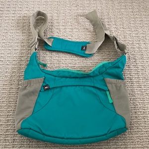 REI teal hiking shoulder bag with multiple pockets